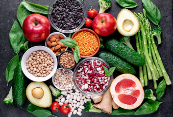 Healthy food. Fresh fruits, vegetables and seeds on a stone background.