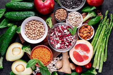 Healthy food. Fresh fruits, vegetables and seeds on a stone background.