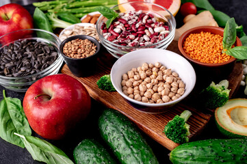 Healthy food. Fresh fruits, vegetables and seeds on a stone background.