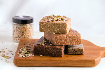 Halva vegan sprinkled with seeds on a light background
