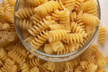 Uncooked pasta spiral close-up. Soft light.