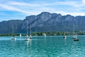 Mondsee with mountains and sailing boats on the water summertime