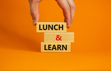 Lunch and learn symbol. Wooden blocks with concept words Lunch and learn. Beautiful orange...