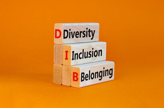DIB, Diversity, inclusion and belonging symbol. Wooden blocks with words DIB, diversity, inclusion and belonging on beautiful orange background. Business, diversity, inclusion and belonging concept.