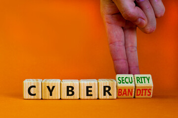 Cyber-security vs cyber-bandits symbol. Businessman turns wooden cubes, changes words Cyber-bandits to cyber-security. Beautiful orange background. Cyber-security vs cyber-bandits concept. Copy space.