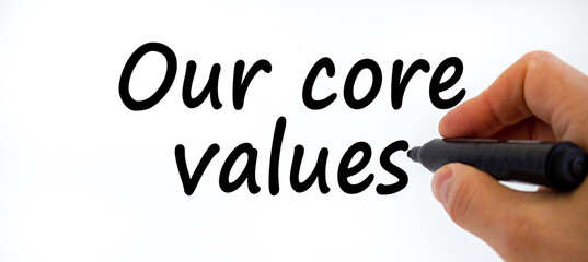 Our core values symbol. Businessman writing 'Our core values', isolated on white background....