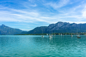 Mondsee with mountains and sailing boats on the water summertime