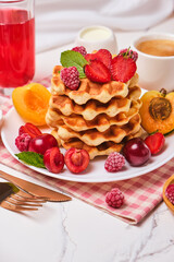 Homemade baked traditional Belgium waffles with berry fruits