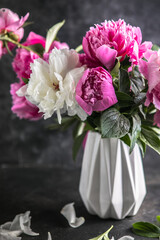 Fresh Peony flowers in vase. bouquet close up. Stylish floral greeting card. Pink peony flower close-up with selective focus.