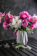 Fresh Peony flowers in vase. bouquet close up. Stylish floral greeting card. Pink peony flower close-up with selective focus.