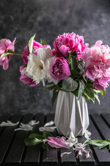 Fresh Peony flowers in vase. bouquet close up. Stylish floral greeting card. Pink peony flower close-up with selective focus.