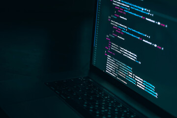 The code on the laptop screen at night. The concept of the SWIFT programming language. Software development. - Powered by Adobe
