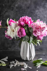 Fresh Peony flowers in vase. bouquet close up. Stylish floral greeting card. Pink peony flower close-up with selective focus.