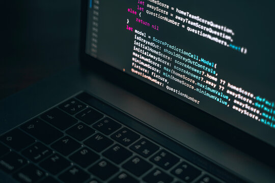 The code on the laptop screen at night. The concept of the SWIFT programming language. Software development.