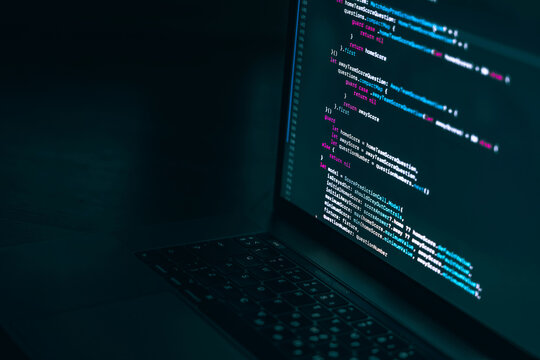 The code on the laptop screen at night. The concept of the SWIFT programming language. Software development.