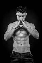 Fototapeta premium Young strong man on dark background