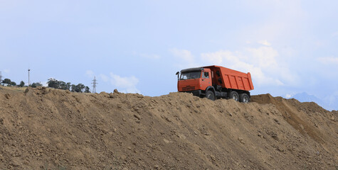 dump truck carries land in summer