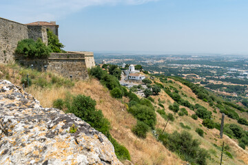 Fototapeta na wymiar Vegetated hill of the castle wall of Palmela overlooking windmills, PORTUGAL