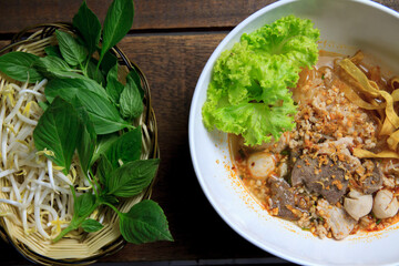 Thai food Spicy TOM YAM pork noodle soup with lemongrass, chilly pasted and lime juice