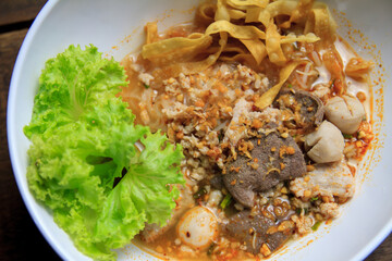 Thai food Spicy TOM YAM pork noodle soup with lemongrass, chilly pasted and lime juice