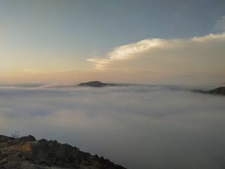 A horizon with white clouds on a peak