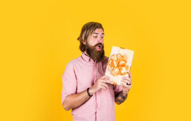 mature brutal hipster with present box in shirt, birthday