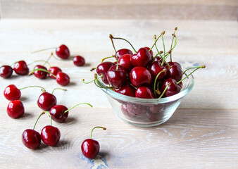 Fresh ripe red berries on a bowl on the rustic background