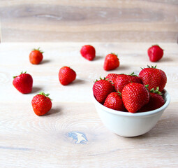 Fresh ripe red strawberries on a bowl on the rustic background