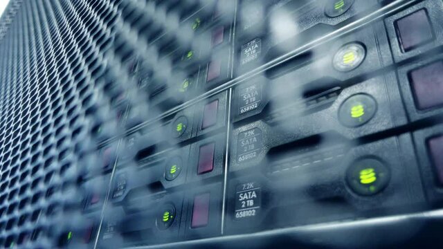 Information recording process. Blinking bulbs on hard drives in a server cabinet, close-up. HDD concept.