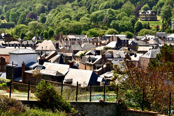 Fototapeta na wymiar Bright sunlight reflecting off the roofs of houses in Etretat, France. Town in Normandy.