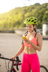 Young pretty girl in bright sportswear with a smartphone
