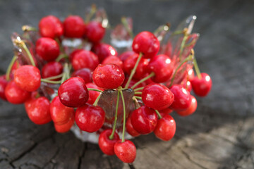 Red berries.Fresh red Sweet cherries on the wooden table. Red Cherries.Fresh ripe sour cherries in a wine glass.Food background.Red juicy Sweet cherries. Soft focus.Copy space.horizontal