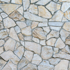 stone wall made of sandstone blocks of different sizes as the background