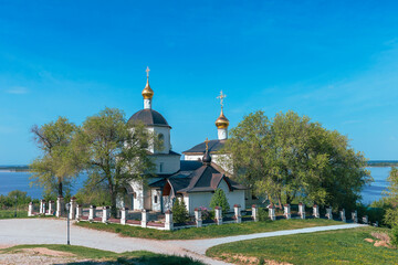 Fototapeta premium A beautiful small church on the bank of a wide river in the city of Sviyazhsk near the capital of Tatarstan Kazan