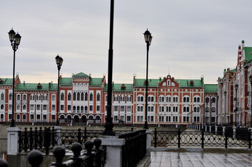 View through the railings on the embankment of Bruges in cloudy weather. Russia Yoshkar-Ola 01.05.2021. High quality photo