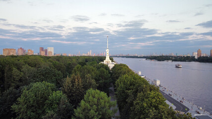 Obraz premium Sunset, river port in Moscow with beautiful nature, ships, containers. Drone view in the evening. Night building with lights.