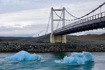 Icebergs swimming under the bridge of Hringvegur, Route 1 at Jökulsárlón glacier lagoon,...
