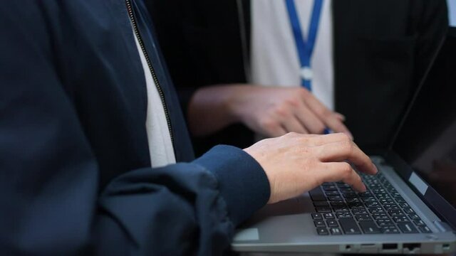 slow motion scene programmer hand type on keyboard on laptop to input code language into software for study bug and defect of system during suggest by specialist at office for educational technology	