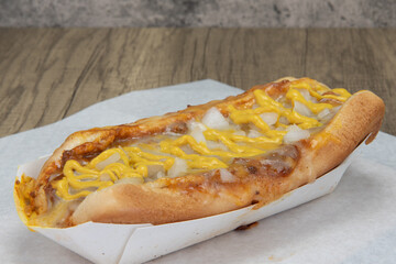 Loaded chile cheese hot dog smothered in cheese, chile, and onions.