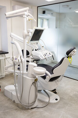 A modern dental office with new equipment and a dental chair. Cabinet for dental treatment
