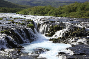 Naklejka na ściany i meble The beautiful blue water of Brúarfoss waterfall, Iceland