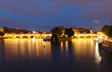 Fototapeta na wymiar CItyscape of downtown with Pont Neuf Bridge and River Seine at night , Paris .