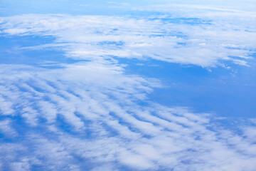 Flying over the cirrus clouds . Earth atmosphere view from aircraft window