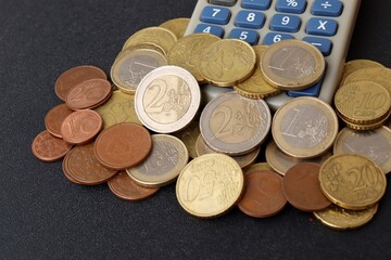 Euro coins and calculator. Cent coins, euro cents. Finance, taxes in Europe concept.