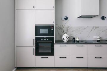 Minimalistic interior kitchen design. White grey marble kitchen room organization