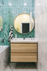 Stylish modern luxurious marble and green tiles bathroom with washbasin