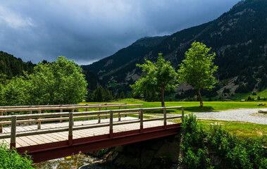 Obraz premium Small wooden bridge to the lake in Vall de Nuria valley Sanctuary in the Catalan Pyrenees, Spain,Europe