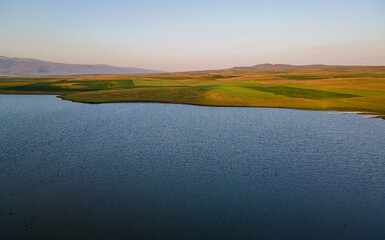 Beautiful sunrise time lapse sky and clouds, panoramic view on the lake and mountains.