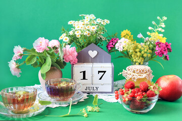  Calendar for July 17 : the name of the month of July in English, cubes with the number 17,...