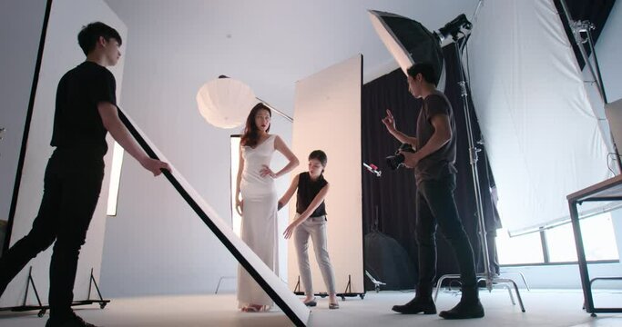 Photographer taking pictures of female model in studio,4K